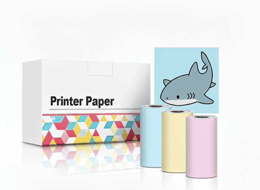 Set of three non-adhesive thermal paper rolls in pastel blue, yellow, and pink, shown next to the 'Printer Paper' box and a sample print of a cute shark doodle.
