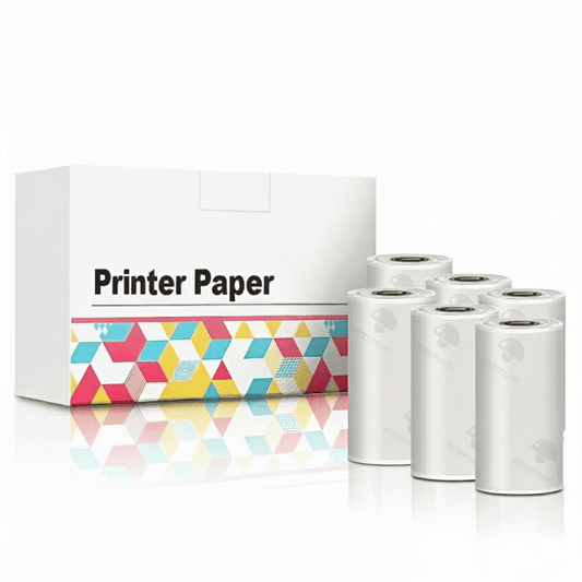 Set of six transparent (clear) thermal printer paper rolls, often used for stickers, displayed next to the white 'Printer Paper' retail box.